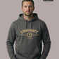 Ein Mann trägt einen dunkelgrauen Hoodie mit goldenem „STANDHAFT“-Schriftzug und Lorbeerkranz-Logo auf der Brust.