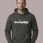 Mann in dunkelgrauem Hoodie vor grauem Hintergrund. Auf der Brust ist der weiße Schriftzug „awayday STANDHAFT“ mit einer bunten Sitzreihen-Grafik.